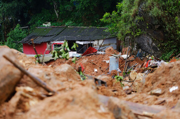 A house stands damaged by a landslide caused by heavy rains in the southeastern coast of Guaruja,...