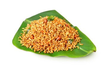 South Indian Traditional Puliogare, Puliodharai or tamarind rice on a banana leaf, isolated. Temple meal