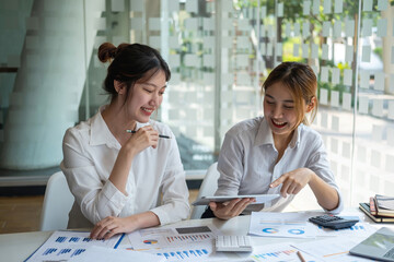 Marketing, Financial, Accounting, Planning, Team of female businessmen and economists use calculators and computers and graph documents to profit the company.