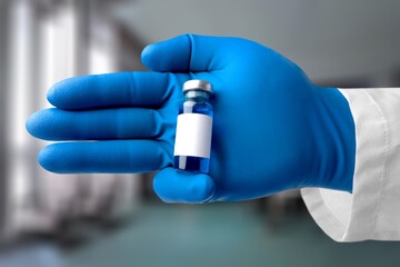 Medical hand holds vaccination for booster Doctor with vial of the doses vaccine. Vaccination and...