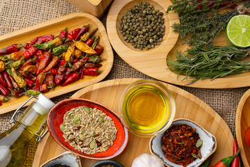 Close up of wooden board with spices, herbs and cooking ingredients