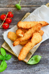 
 Crispy  deep Fried home made    Chicken strips Breaded  with  almond flour chicken  breast fillets  with chilly peppers and fresh   basil on wooden rustic background. Ketogenic diet food
