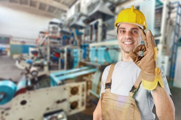 A man workers engineering standing with safety helmet in front of indoor factory. Concept of smart industry worker operating.