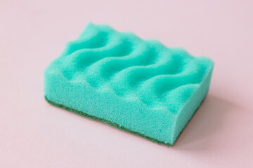 Obraz na płótnie Canvas Green sponge and foam on pink background