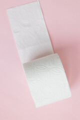 White roll toilet paper on the light pink background