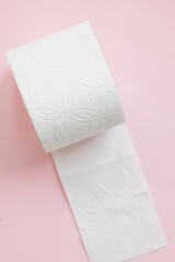 White roll toilet paper on the light pink background