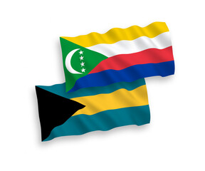 National vector fabric wave flags of Union of the Comoros and Commonwealth of The Bahamas isolated on white background. 1 to 2 proportion.