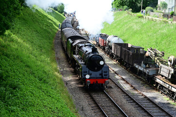 Steam locomotive pulling a passenger train at a Heritage railway in the UK