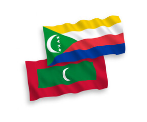 National vector fabric wave flags of Union of the Comoros and Maldives isolated on white background. 1 to 2 proportion.