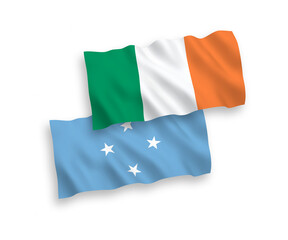 National vector fabric wave flags of Ireland and Federated States of Micronesia isolated on white background. 1 to 2 proportion.