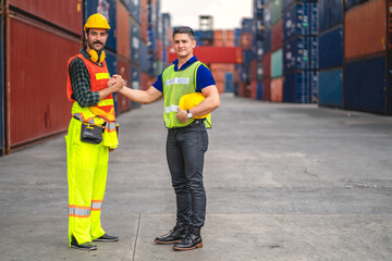 Professional engineer container cargo foreman team in helmets working standing and using walkie talkie checking stock into container for loading.logistic transport and business industry export
