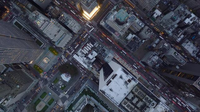 Aerial birds eye overhead top down panning view of traffic jam in downtown. Clogged crossroads by vehicles between high rise buildings. Manhattan, New York City, USA