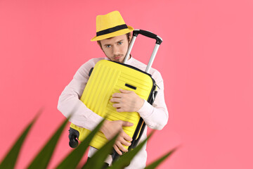 Concept of travel, young man on pink background