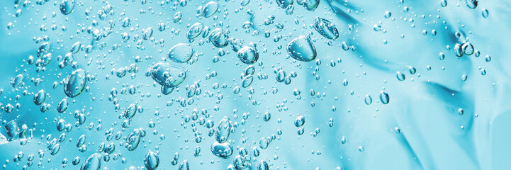 Close up macro Aloe vera gel cosmetic texture blue background with bubbles. Lemongrass gel skincare product. antibacterial liquid with aloe vera, moisturizing. Safe and environmental friendly. - obrazy, fototapety, plakaty