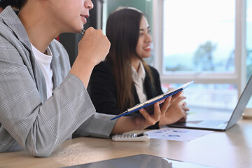 Attentive young businesspeople listening intently during discussion of business ideas in board room