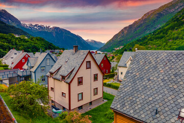 Typical Norwagian architecture in Odda town, Hordaland county, Norway. Beautiful summer sunrise on Hardangerfjord fjord. Traveling concept background.