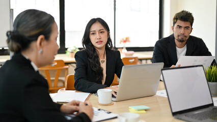 Female marketing manager presenting her project plan to senior female executive manager.