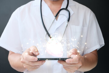 Doctor holding a virtual heart in his hand. shows a hand-drawn human organ with the color blue...