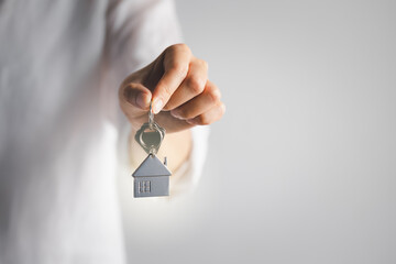 hand holding home key on white background