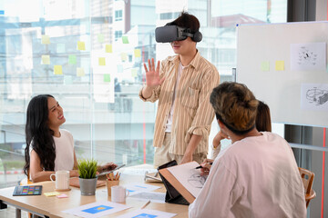 A man wearing a VR glasses to test a new virtual innovation experience in the meeting.
