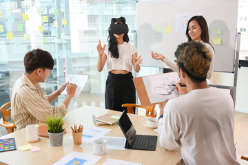 A group of tech developers testing a new version of VR game via VR headset.