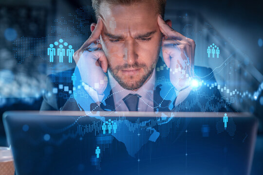 Handsome businessman in suit at workplace working with laptop to hire new employees for international business consulting. HR, social media hologram icons over office background