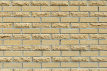 Solid yellow and beige brick wall. Brick background.