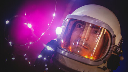 Spaceman in the in helmet and spacesuit on the blinking stars background concept.