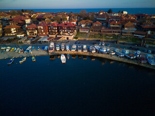 A lot of boats and boats on the pier near the Black Sea against the backdrop of sunset