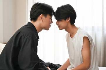 Two handsome young Asian gay men face to face, showing some affection of LGBT.