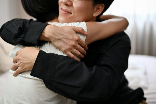 Asian Teen Gay Couple Hugging Cuddling Each Other In Bedroom.