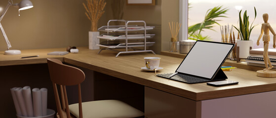 Modern comfortable workstation interior design with portable tablet on wooden table