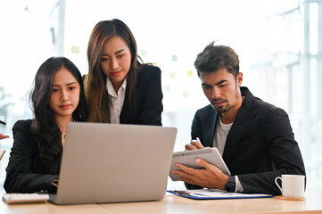 A group of professional asian businesspeople having a informal meeting