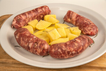 Sausages with fennel with potato garnish on a white plate