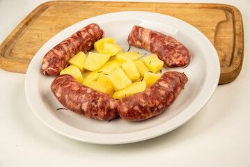 Sausages with fennel with potato garnish on a white plate