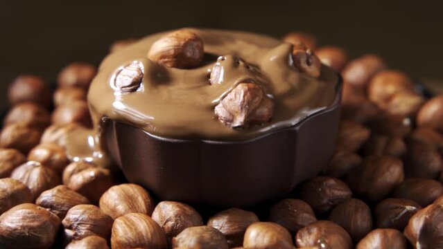 Pouring hot melted chocolate and almond nuts texture, close up, , 4k.