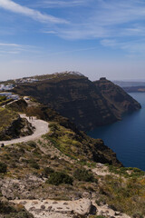 Fototapeta na wymiar Coastal pathway leading to Imerovigli from North Santorini. Skaros rock can be seen in the distance. Portrait image.