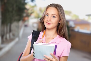 Fototapeta premium Woman with notebooks outside school ready to go to study