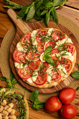 Margarita Pizza with tomatoes and species in a wood table 2