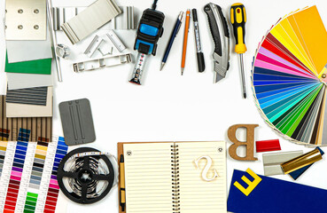 Outdoor advertising agency tools, accessories and material samples. Top view. No people. Isolated.