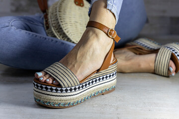 Sexy woman posing in Stylish summer foot ware and purse