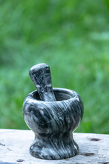 Manual ceramic mortar with a pestle for grinding spices. Cooking tricks. Kitchen utensils. Chop pepper. Fragrant spices.