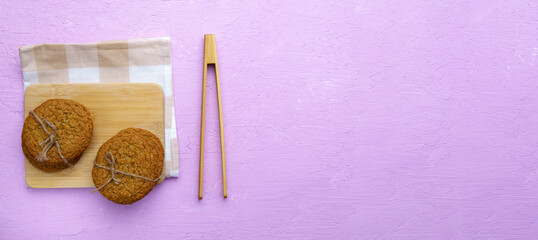 Oatmeal cookies from a plate. Top view. Craft homemade food. View from above. Pink background. Copy space