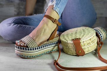 Sexy woman posing in Stylish summer foot ware and purse