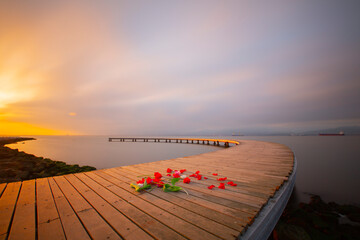 The pier like a boomerang at sunrise was captured with the long exposure technique.