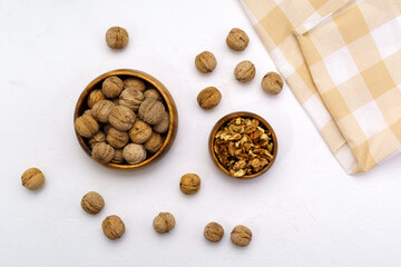 Walnut kernels on a table stone white background, flat lay.