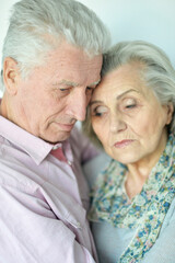 Close-up portrait of sad senior couple posing