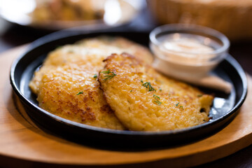 Fried grated potato pancakes with sour cream