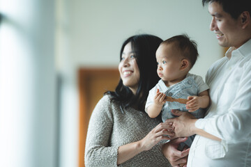 young Asian family are happy together at home by life insurance concept, child baby and mother and father having fun and smile with love, childhood living in cozy lifestyle with dad and mom © chokniti