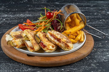 Bazlama Toast,Turkish toast flat baked bread called bazlama with Turkish sausage and cheese served with fried patatoes,salad and a glass of tea